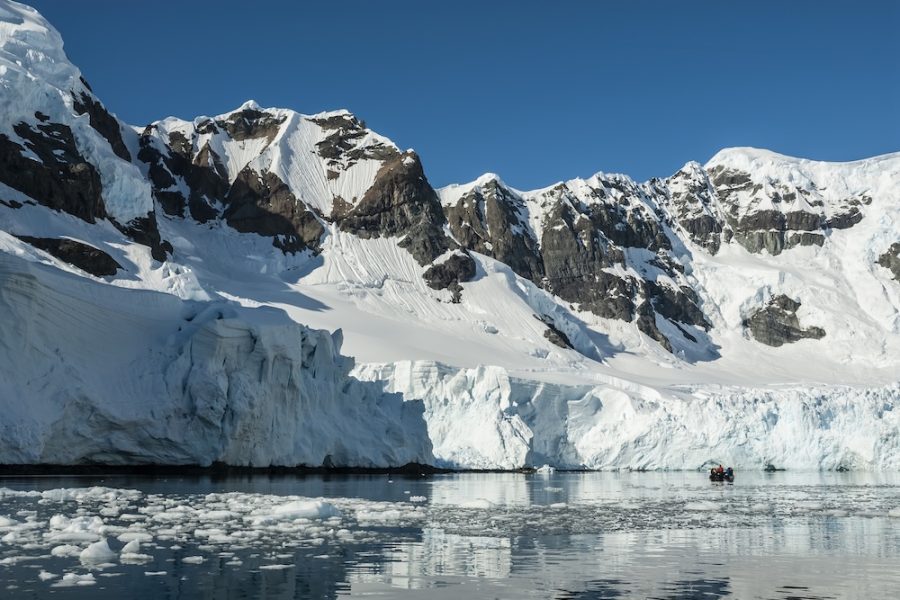 Tourists watching glaciers and mountains in Paradise bay, Antarctic peninsula, Antartica..