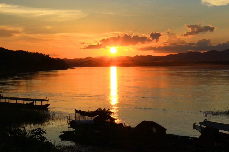 Tradition of Long tail boat and fisherman in beautiful sunset twilight at Khong river the Thai-Laos border Chaingkhan distric Thailand