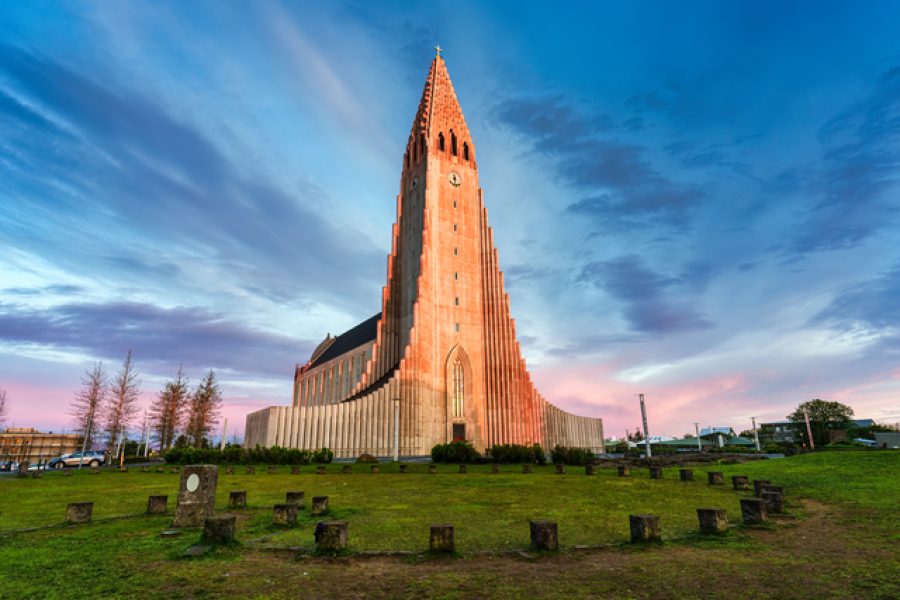 Beautiful sunset sky shining on Hallgrimskirkja Lutheran parish church is the largest church in centre of Reykjavik downtown at Iceland summer