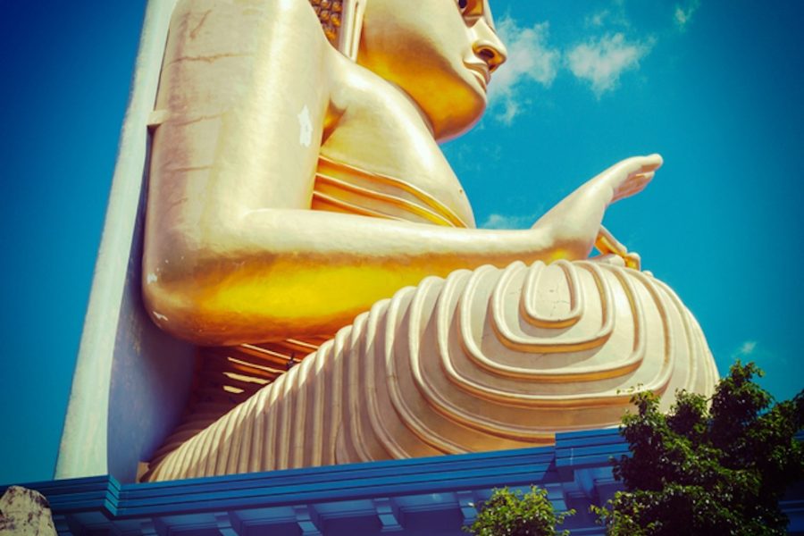 Vintage retro hipster style travel image of gold Buddha. Golden Temple, Dambulla, Sri Lanka